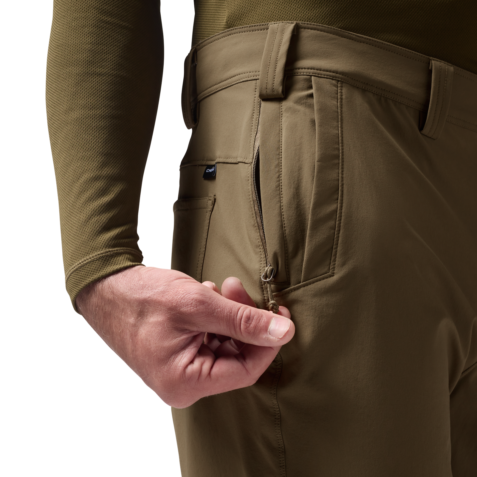 Person wearing tan pants with a olive green shirt, focusing on the pants' pocket. #field_khaki