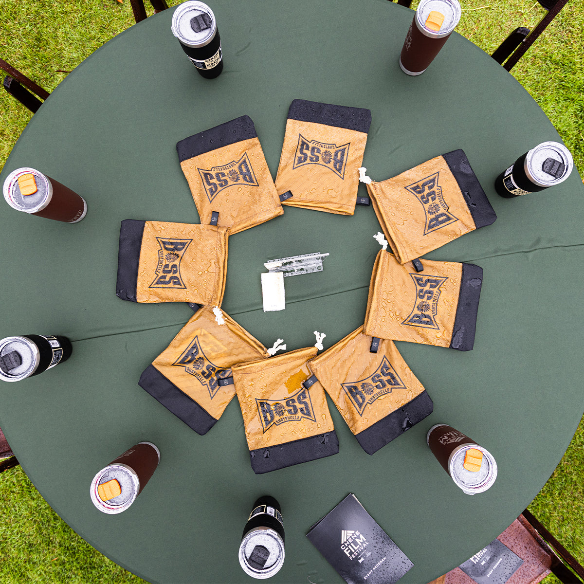 A private table at an event with place settings, dishes, and drinks arranged for eight guests, marked with a 'SVIP' sign in the center.