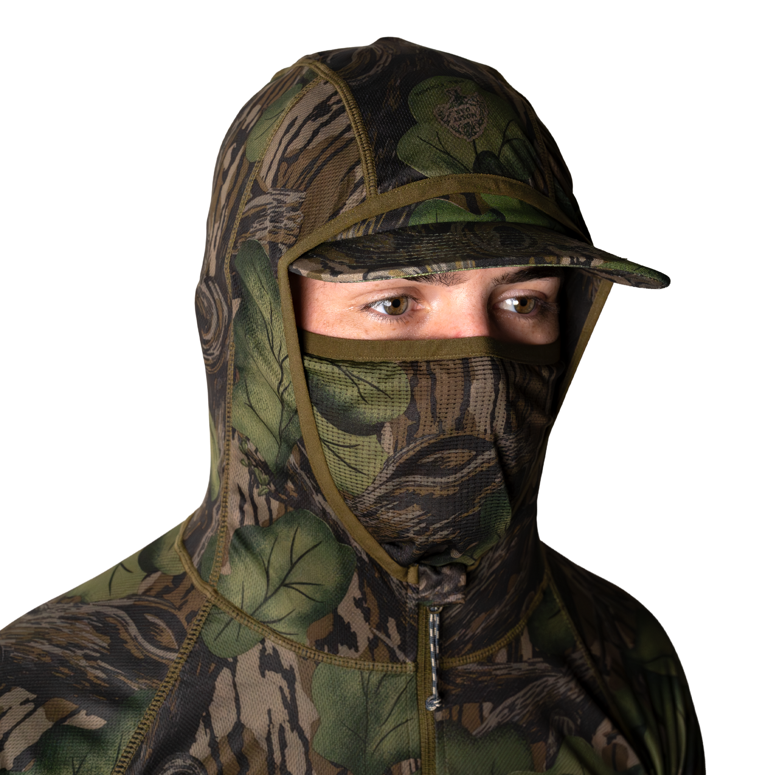Model wearing a green and brown camouflage hoodie with built in face mask and brimmed cap, front view on light background. #mossy_oak_full_foliage