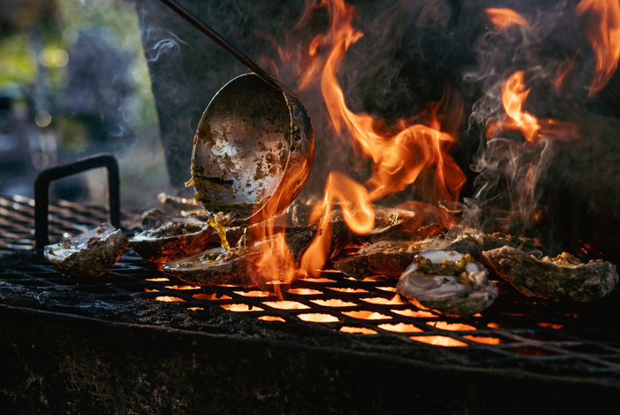 a clams being cooked on a grill
